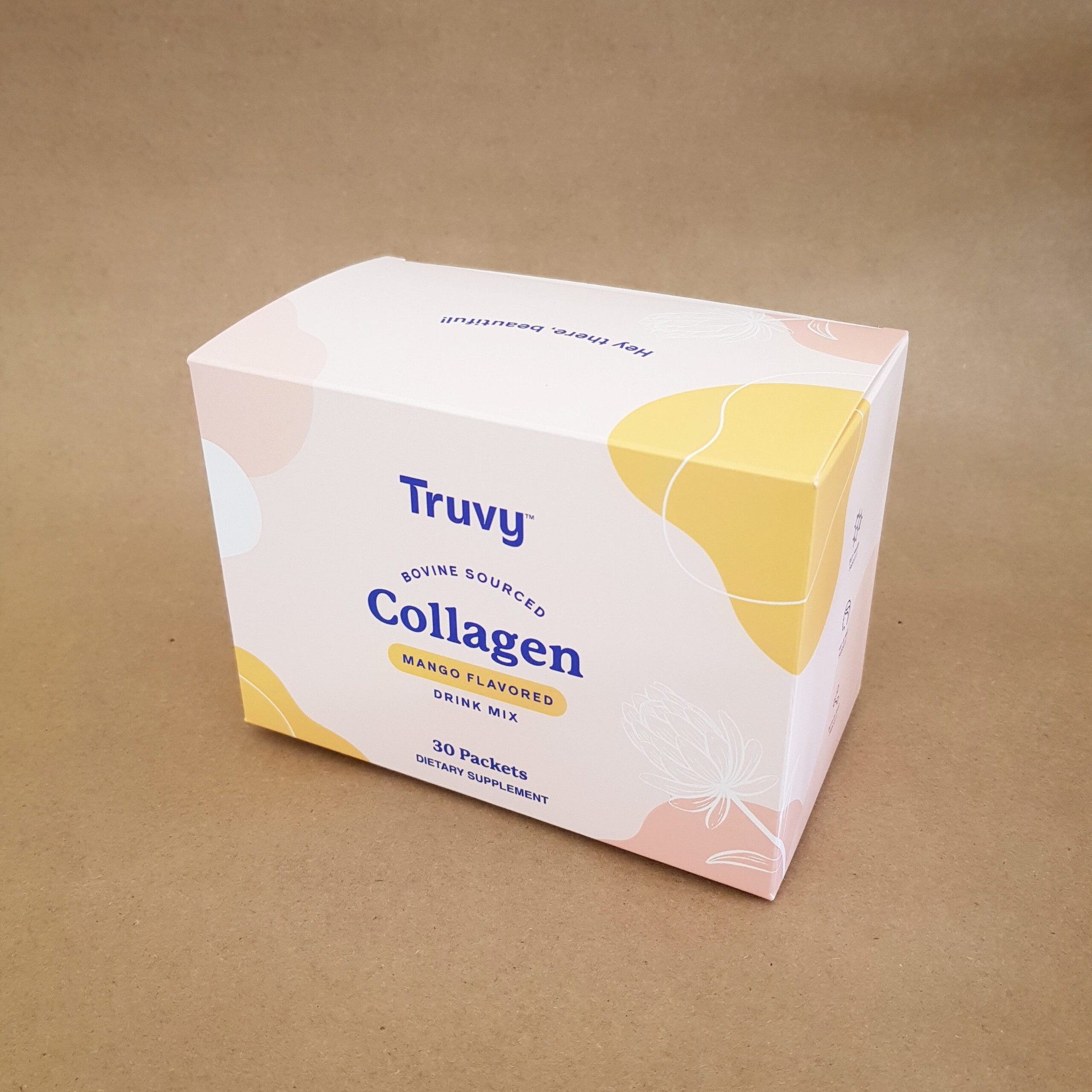 Truvy bovine sourced mango collagen drink mix folding carton in pastel pink and yellow with protea illustration